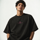 Close-up of the Sinners Oversize T-Shirt worn on a model, showing the pink chest logo and dropped shoulders